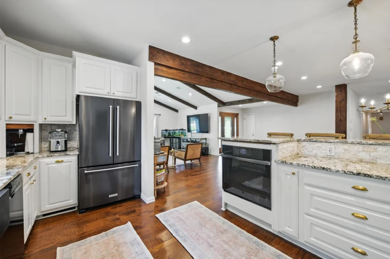 Kitchen with French-door refrigerator and exposed wood beam